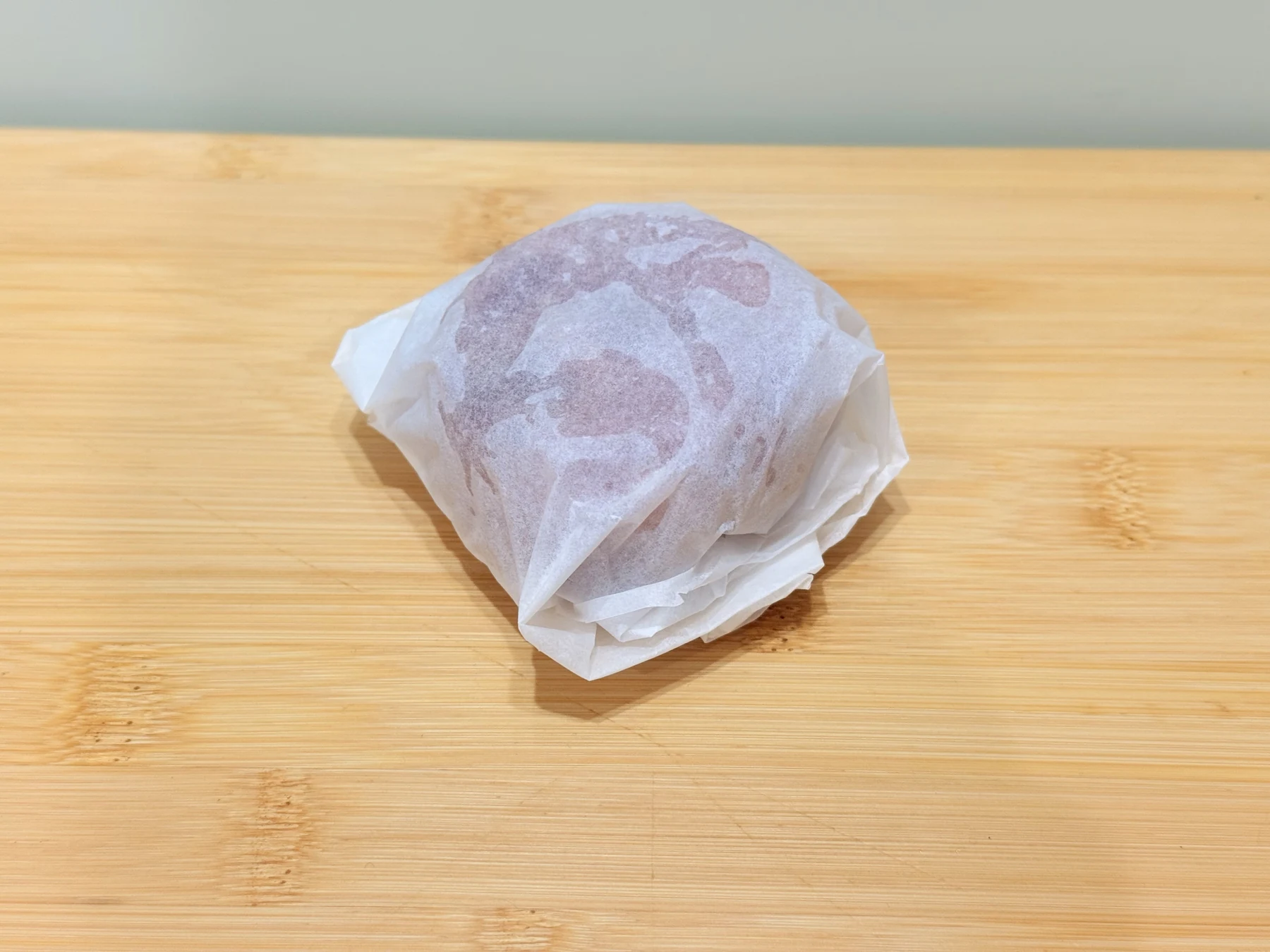 A Cats That Raw frozen puck wrapped in parchment paper